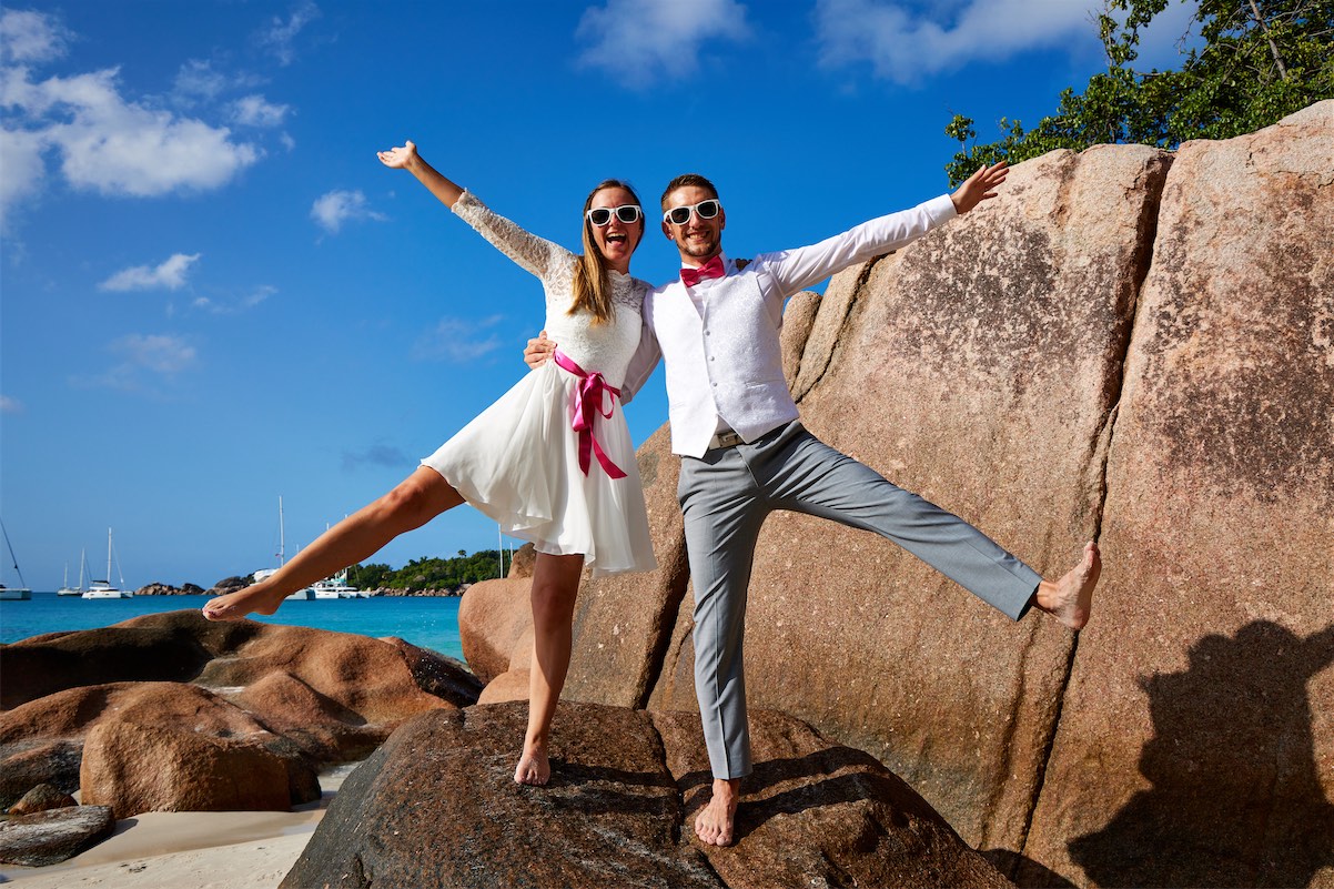 A romantic wedding moment captured in the Seychelles Islands, featuring a couple against a backdrop of stunning tropical scenery.