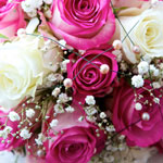 A beautiful wedding bouquet featuring pink and white roses, perfect for a romantic Seychelles honeymoon.