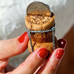 A person with a small wine cork bottle, representing a cherished moment from a wedding or honeymoon in the Seychelles.