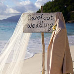 A picturesque wedding ceremony on a beach in Seychelles, perfect for a romantic honeymoon setting.