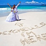 A stunning Seychelles wedding scene featuring a beautifully decorated altar on a sandy beach with turquoise waters.