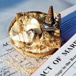 A wedding ring adorned with shells rests atop a marriage certificate, evoking a romantic Seychelles honeymoon theme.